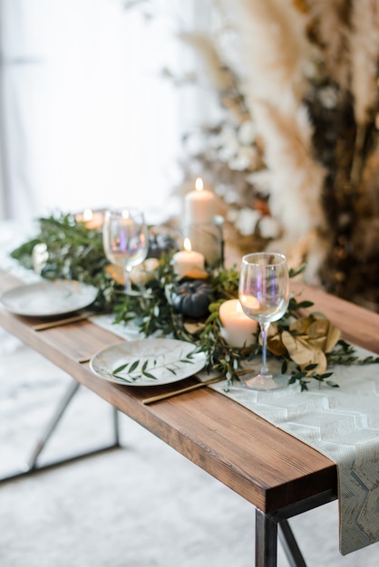 Halloween Table setting on dark background. Dish on a dark table with black and gold pumpkin. Flat lay, top view trendy holiday concept.