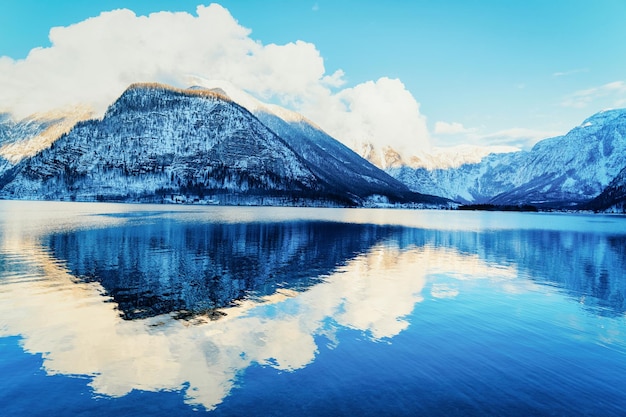 Hallstatt and Alps mountains near Salzburg of Austria, Europe. Winter in Salzkammergut. Travel to Austrian city with lake at Christmas. Alpine Land with snow. View on Village