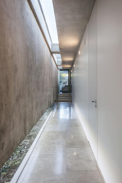 a hallway with a door that has a glass door