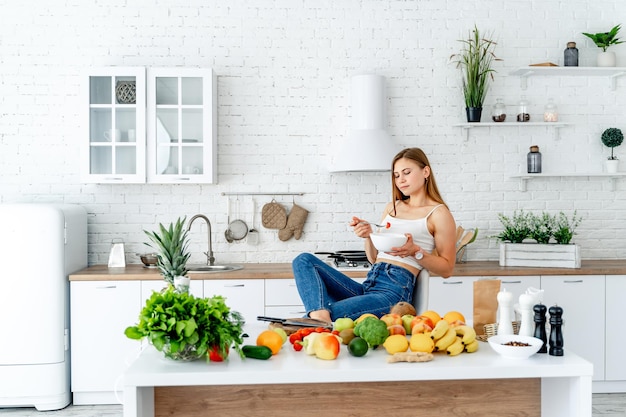 Halthy fruits and vegetables in the modern kitchen. Woman cooking with healthy diet food.