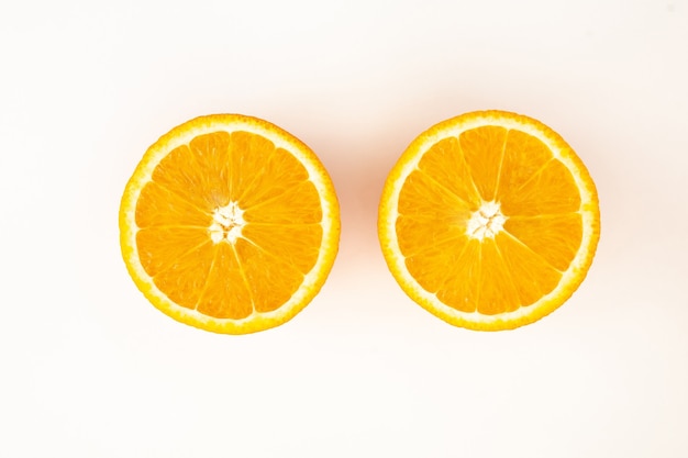 Halved orange on a white background top view