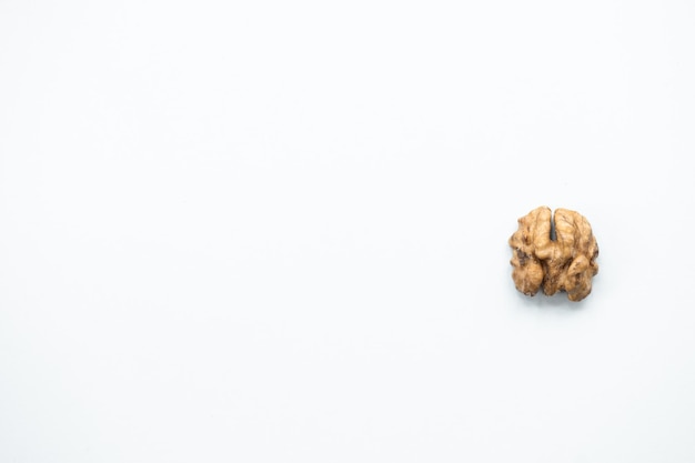 Photo halves of walnuts on white background pattern top view