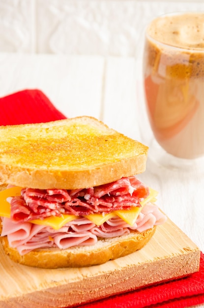 Ham cheese and salami sandwich with coffee with milk White background