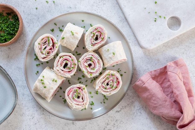 Ham and cream cheese rolled up in a tortilla