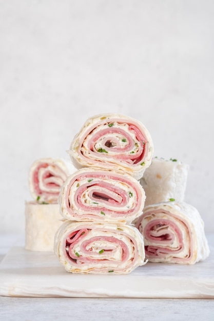 Ham and cream cheese rolled up in a tortilla