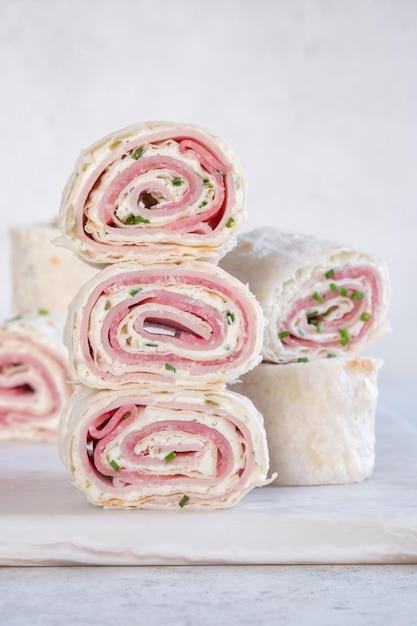 Ham and cream cheese rolled up in a tortilla