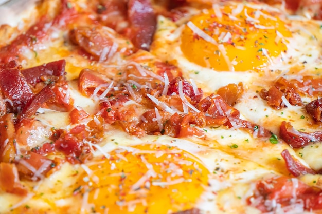 Ham and Eggs Breakfast style pizza on wooden platter