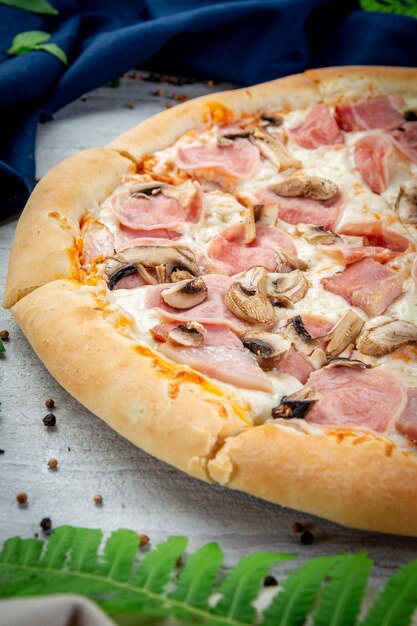 Ham and mushroom pizza on a spatula Freshly baked with parmesan cream sauce ham and mushrooms