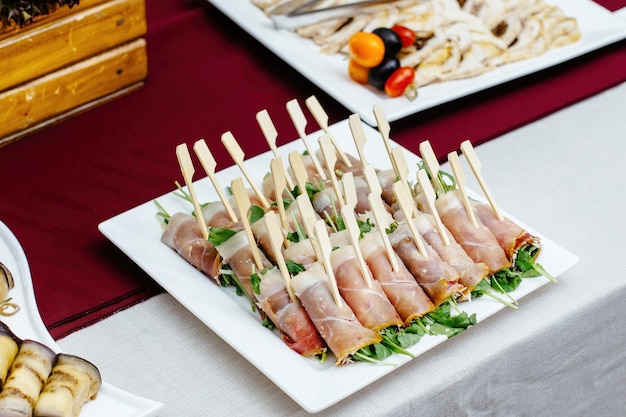 Ham rolls with salad for Breakfast with wooden skewers