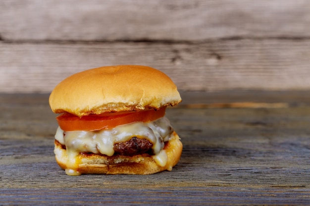 Hamburger. Hamburger on wooden background. Vintage Hamburger. 