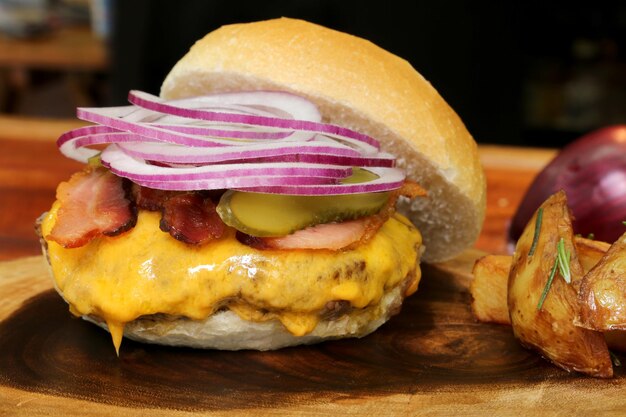 Hamburger Made on the barbecue grill With cheese bacon onion pickle On wooden background