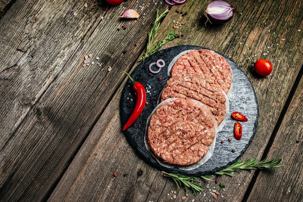 Hamburger patties minced meat for burger beef lamb meat Burger steak on a dark background Long banner format top view