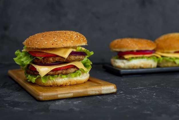 A hamburger with a bun and tomato slices on it