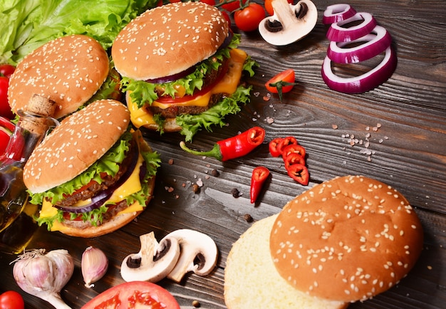 Hamburgers of the best products on a wooden background