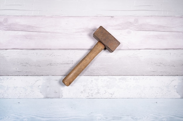 Hammer mason or mass on a background of old boards.