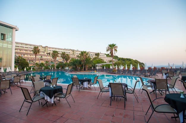 Hammocks with umbrellas by the pool for guests