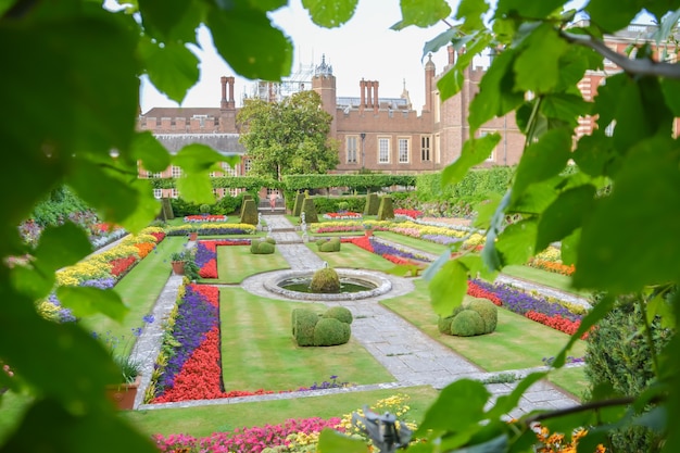 Hampton Court Palace, Brick, England, Lawn, Public Park. LONDON, UK - JULY 21, 2014: Hampton Court was originally built for Cardinal Thomas Wolsey, a favorite of King Henry VIII, circa 1514.