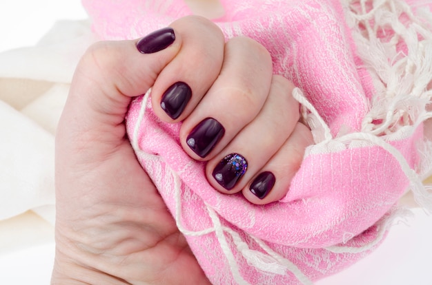 Hand of an adult woman with painted nails