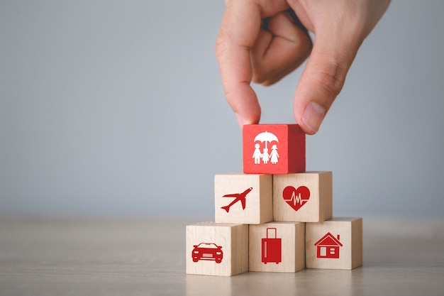 Hand arranging wood block stacking with icons