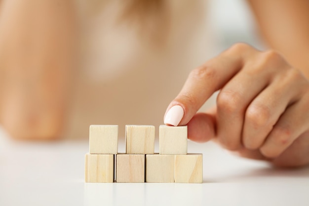 Hand arranging wood block with empty space