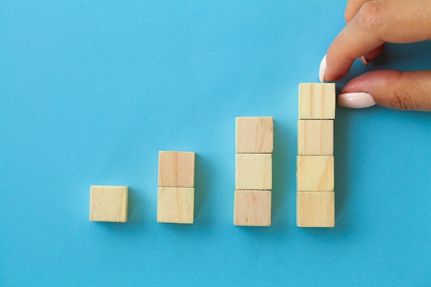 Hand arranging wood block with empty space