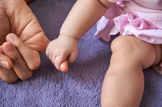 Hand baby holding hand of mother's closeup. concept love of family.