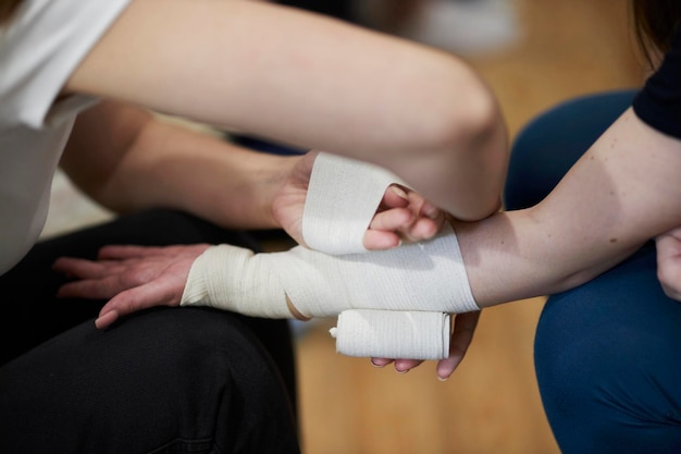 Hand bandaging process. First aid training for people.