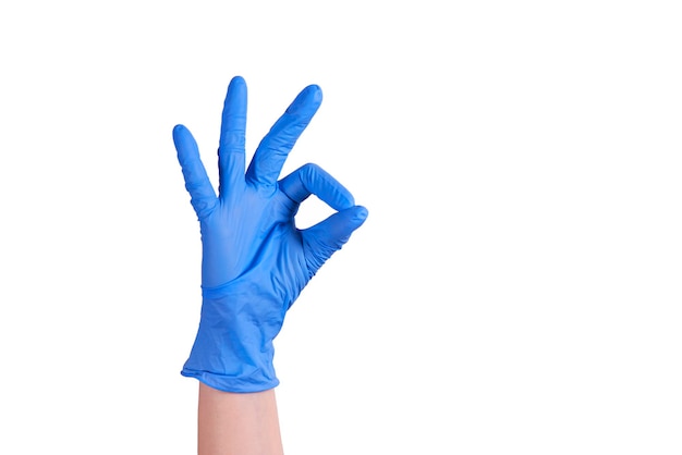 Hand in a blue glove shows a symbol that everything is in order. coronipus pandemic