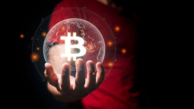 Hand of a businessman is holding a floating gold Bitcoin virtual money on the black background With hightech technology effects Make money with bitcoin Blockchain transfer