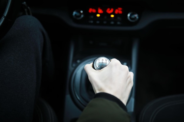 Hand on the car gear knob The driver switches the speed in the car Hand on gear lever