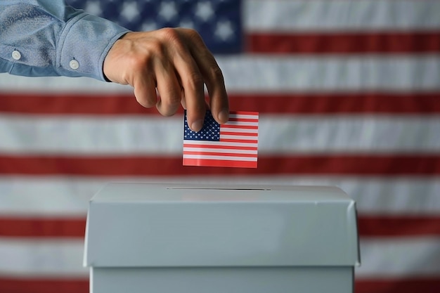 Hand Casting Ballot into Box with American Flag Background Concept of Voting and Democracy