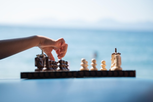 Hand of a child making a move playing chess