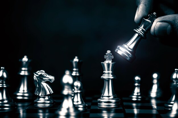 Hand choose king chess fight on chess board concept of team player or business team and leadership strategy and human resources organization management