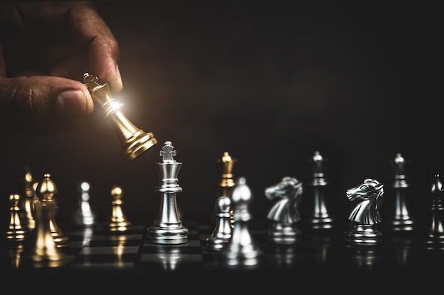 Hand choose king chess fight on chess board concept of team player or business team and leadership strategy and human resources organization management