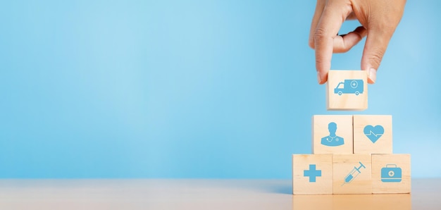 Hand chooses a emoticon icons healthcare medical symbol on wooden block