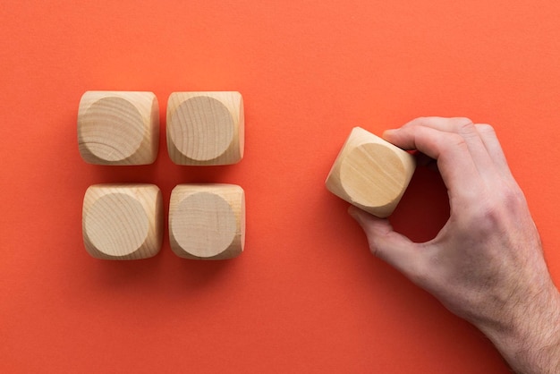 Hand choosing a wooden block from a set Business choice concept