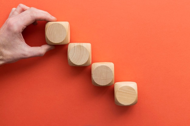 Hand choosing a wooden block from a set Business choice concept