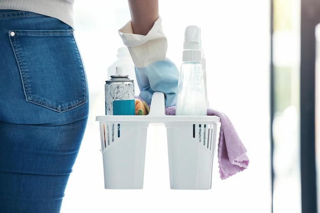 Hand cleaning and product container woman ready for home hygiene and disinfection routine macro Spray liquid and bottles of girl with chemical safety products and cloth to clean house