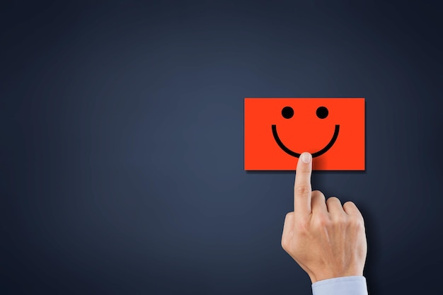 Hand of client show a feedback with bad smile face card. Service rating, satisfaction concept