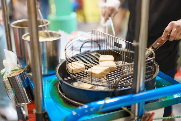 Hand cooking Stinky Tofu at night market famous Taiwanese Street Food of Taiwan exotic food in local market