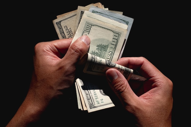 Hand counting American dollars banknotes on black background