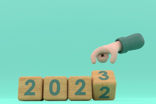 Hand and cubes with 2022 23 represents the new year 2023