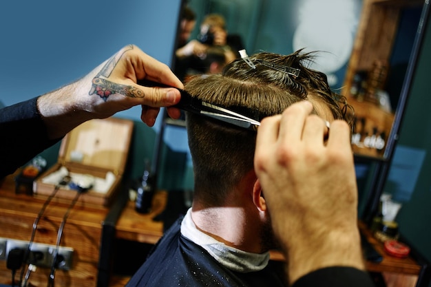 Hand cut with scissors the man in Barbershop closeup