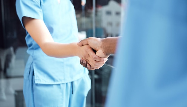 Hand doctor and nurse handshake in hospital for medical healthcare or surgery teamwork or partnership welcome Thank you health care doctors in consultation and workers shaking hands in meeting