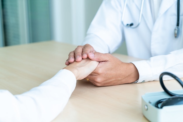 Hand of doctor reassuring her female patient