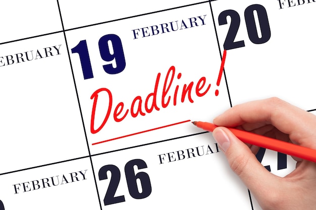 Hand drawing red line and writing the text Deadline on calendar date February 19 Deadline word written on calendar