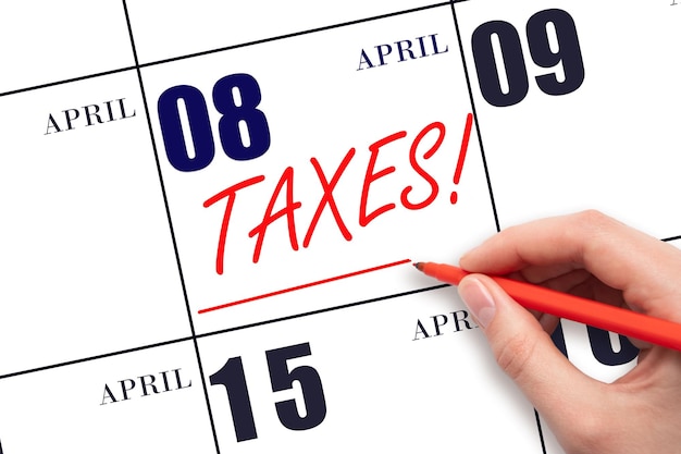 Hand drawing red line and writing the text Taxes on calendar date April 8 Remind date of tax payment