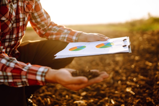 Hand of expert farmer collect soil and checking soil health before growth a seed of vegetable