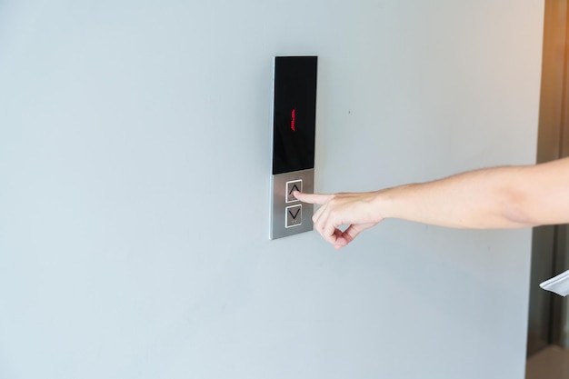 Hand finger press the Elevator button woman waiting for Elevator in office or apartment