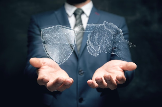 A hand from the net presses the shield Cyber protection Man holding in his hand